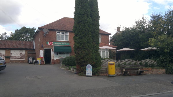 The shop front of Rockland St Mary Post Office and Store on The Street